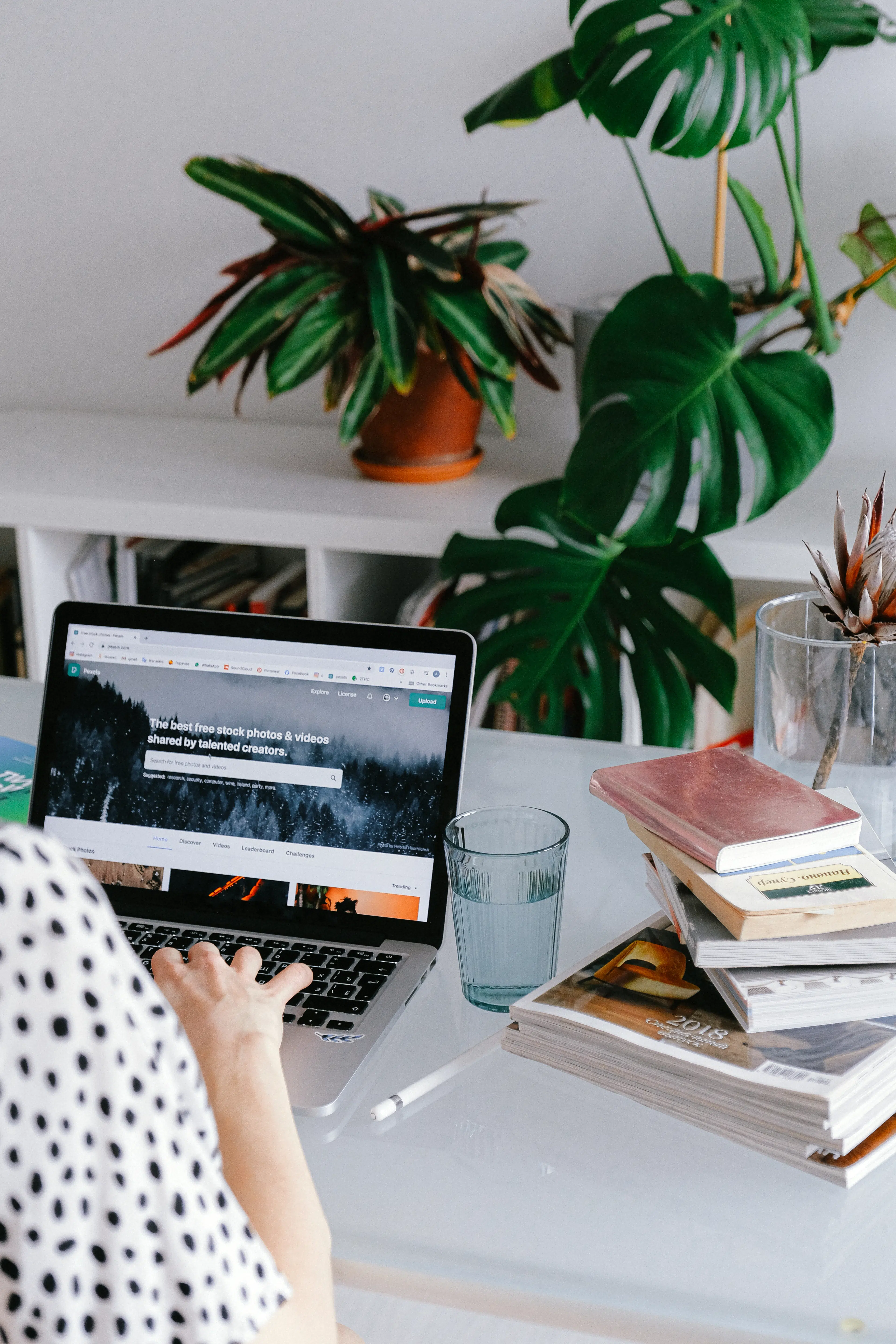 Canva person using macbook pro on table